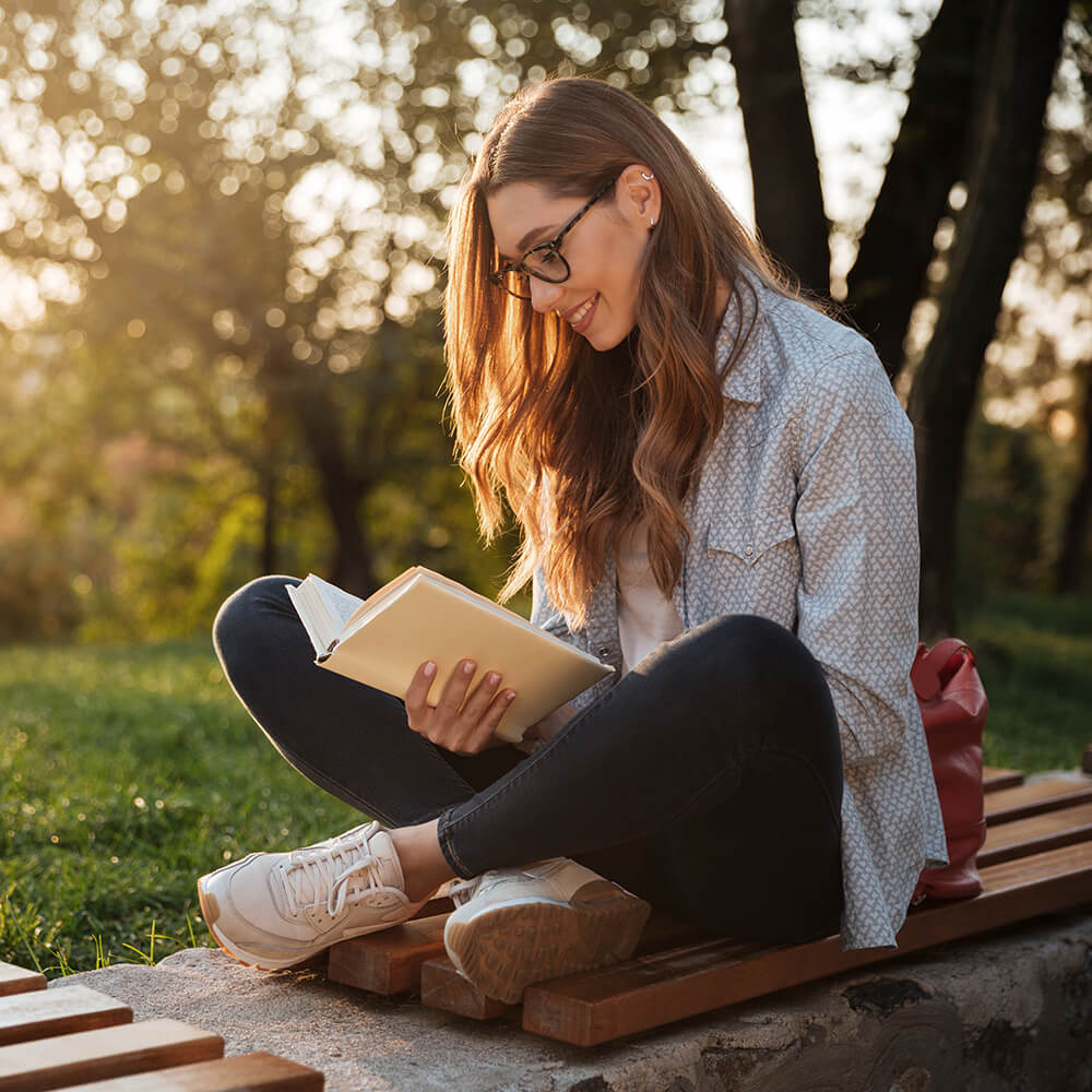 Lady reading outdoors